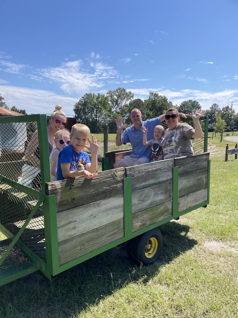 Man two women and three children on tobacco trailer