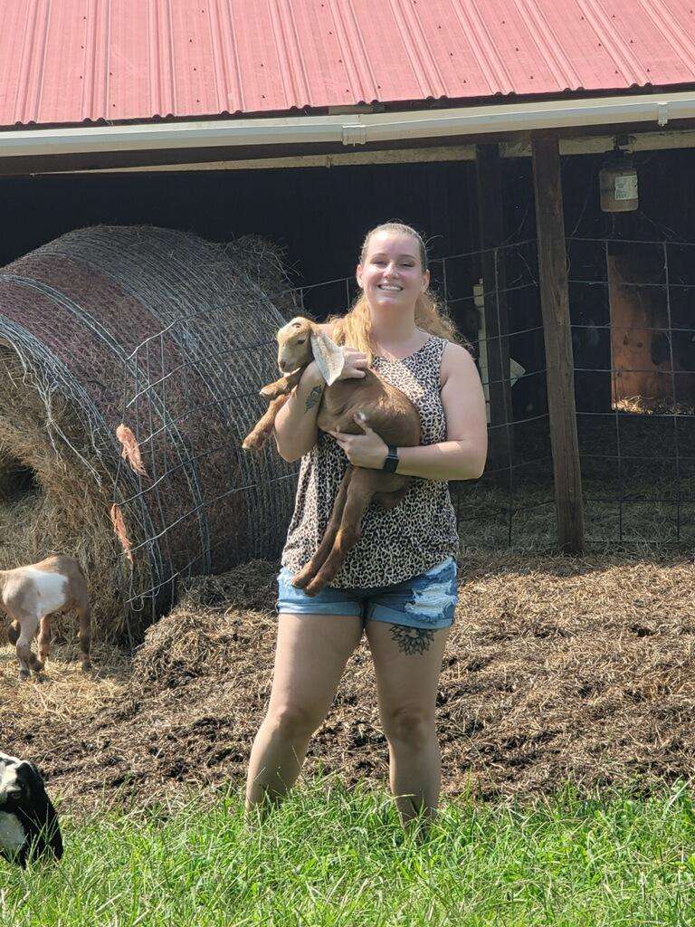 Woman holding baby goats