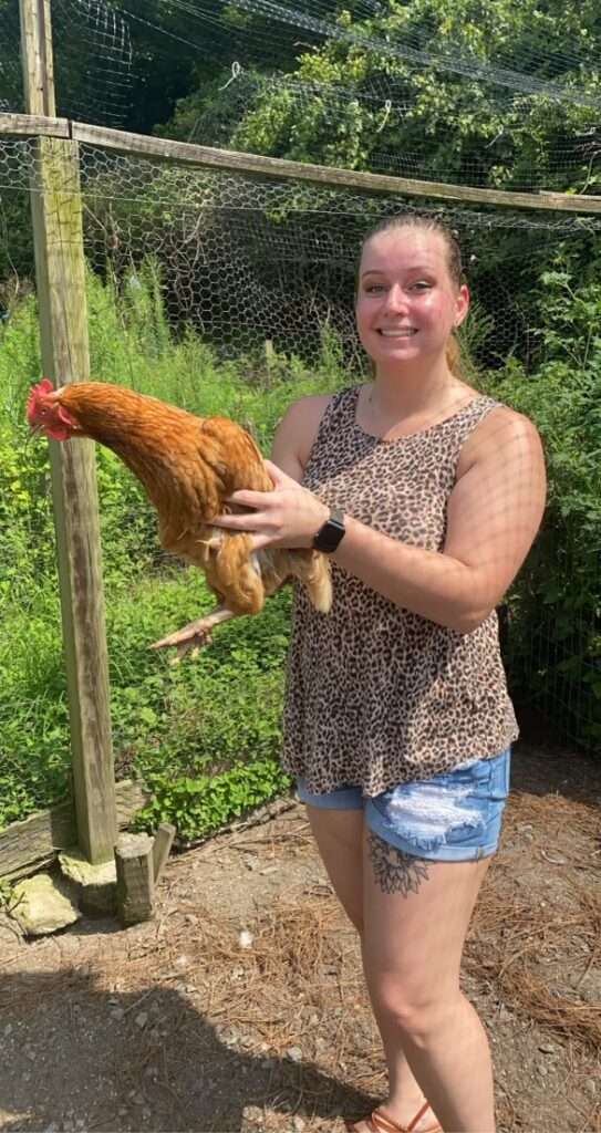 Woman holding a chicken